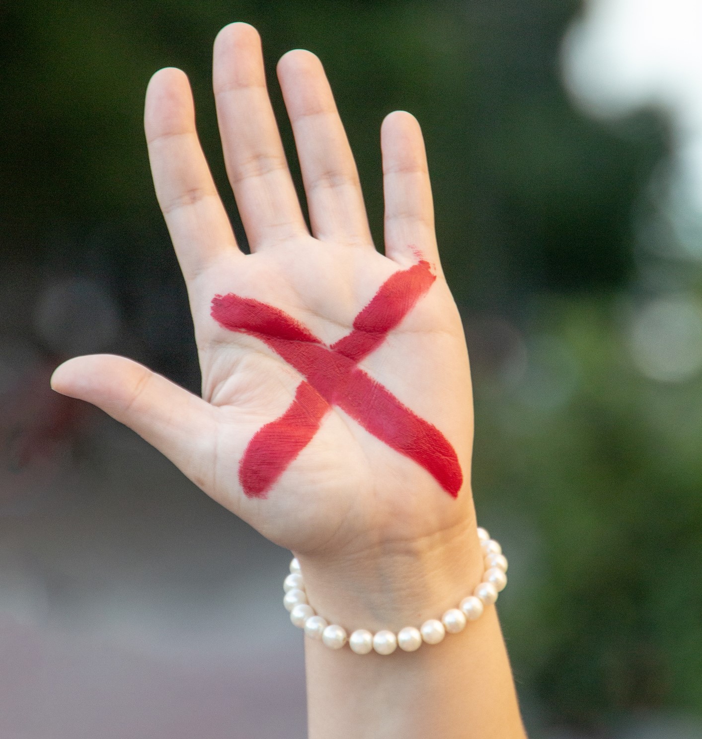 female hand with red x, symbolizing the campaign against domestic violence in Rio de Janeiro in Brazil.