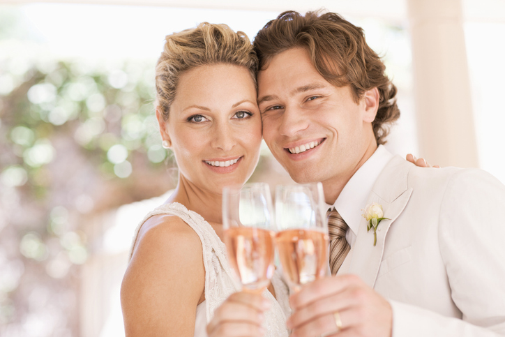 Bride and groom drinking champagne